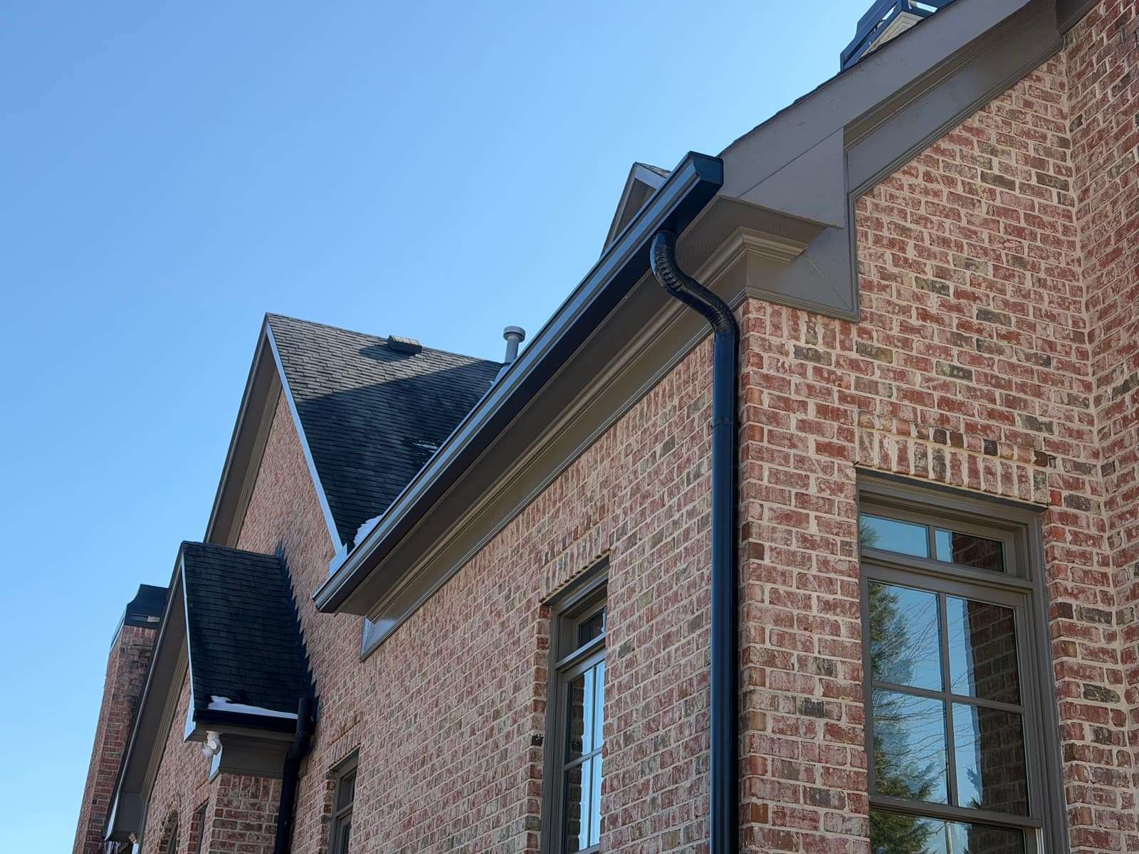Seamless rain gutters installed on a brick home